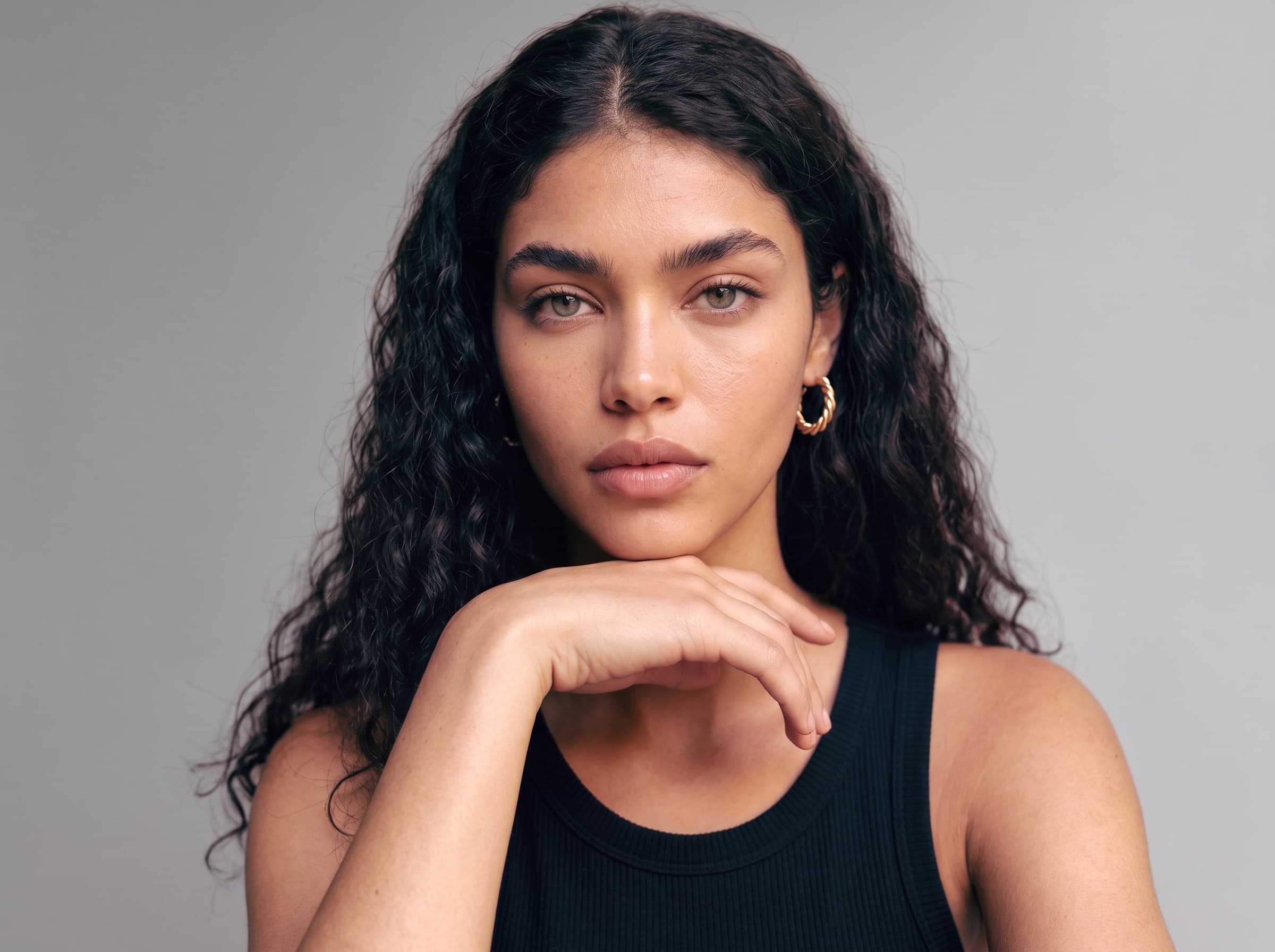 A close studio portrait of a generated model: build, jawline, hair and skin tone described in generic terms